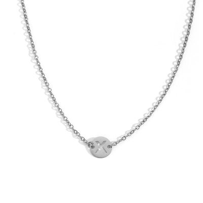 Collar de acero inoxidable plateado  con una medalla pequeña redonda calada en forma de inicial X y cadena forzada